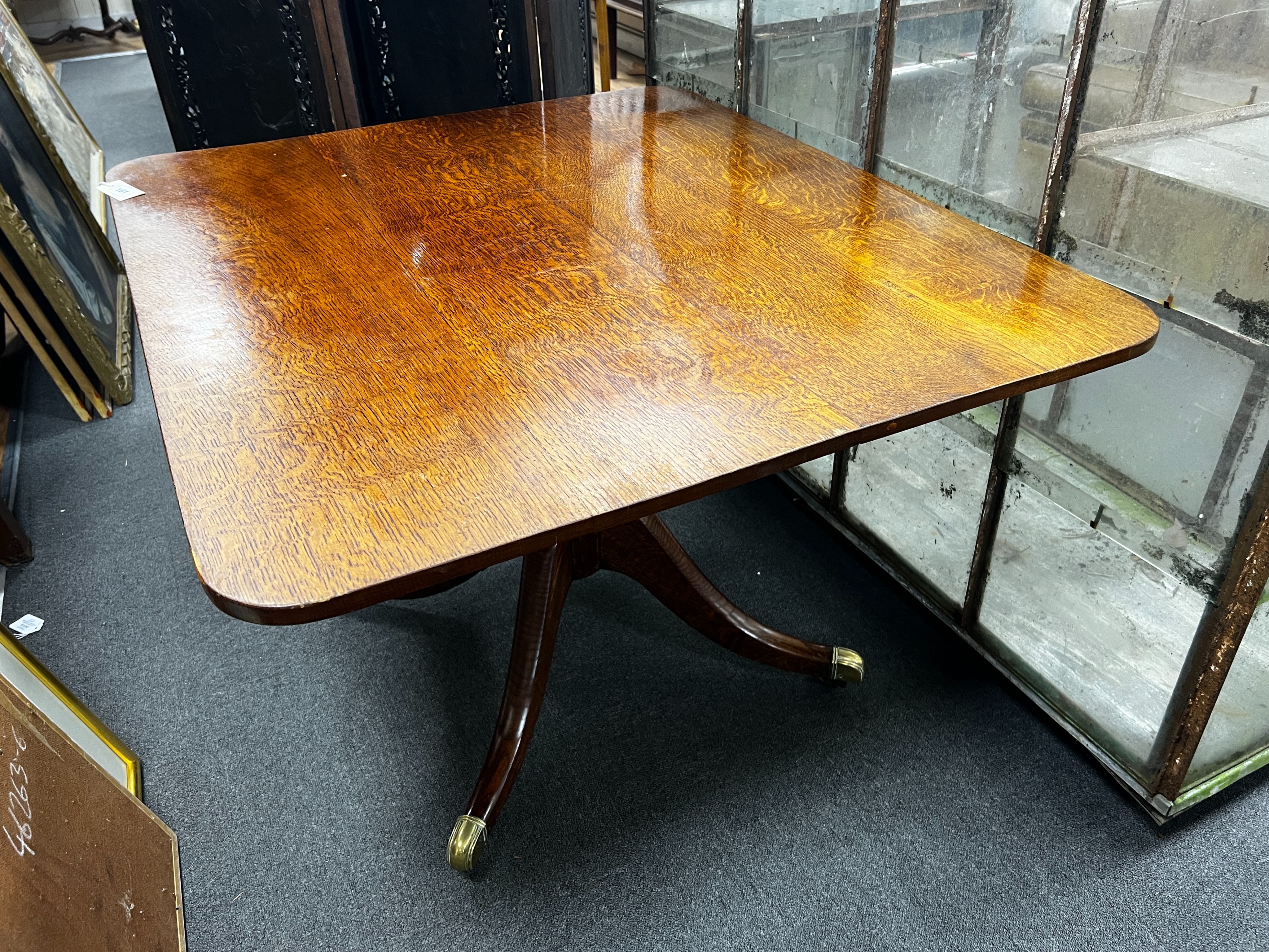 A Regency rectangular oak tilt top dining table, length 110cm, width 94cm, height 72cm